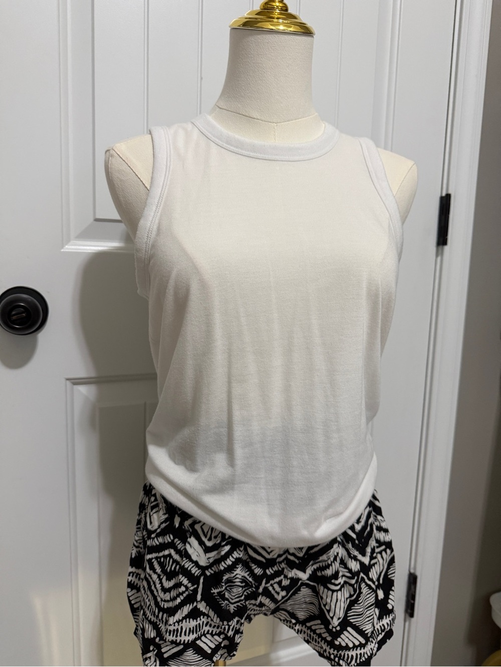 White tank top and patterned shorts